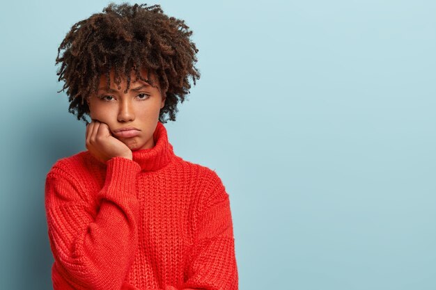 Young woman with Afro haircut wearing red sweater