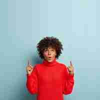 Free photo young woman with afro haircut wearing red sweater