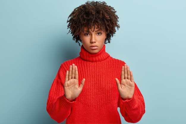 セーターを着てアフロヘアカットの若い女性