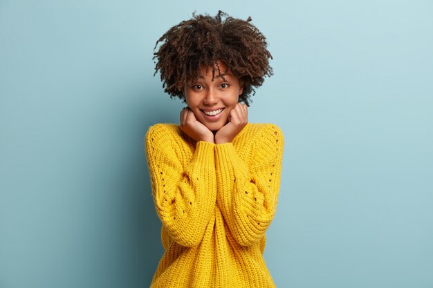 Young woman with Afro haircut wearing sweater