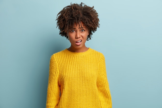 Young woman with Afro haircut wearing sweater