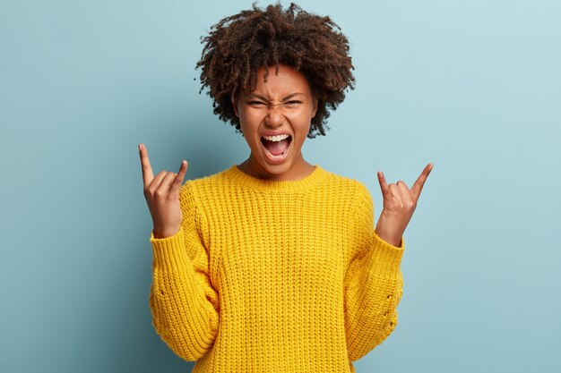 Young woman with Afro haircut wearing sweater