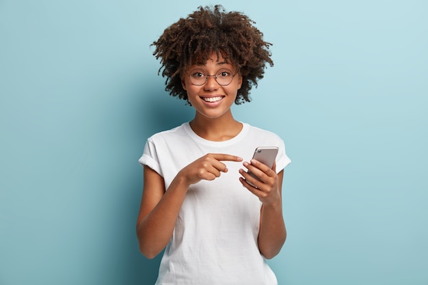 Young woman with Afro haircut wearing white T-shirt