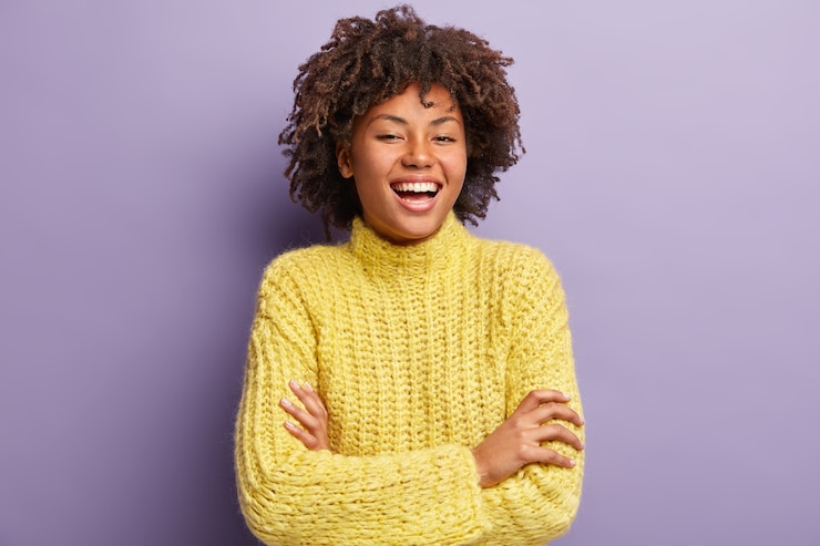 Free Photo young woman with afro haircut wearing yellow sweater