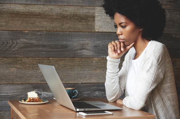 Young woman with Afro hairstyle sitting in cafe