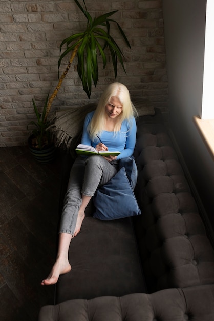 Free photo young woman with albinism and book