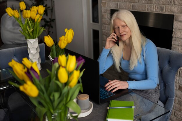 Young woman with albinism and tulip flowers