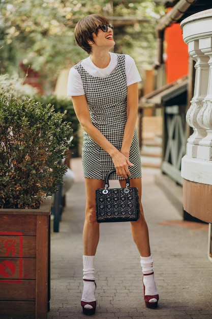 Young woman with bag outside the street