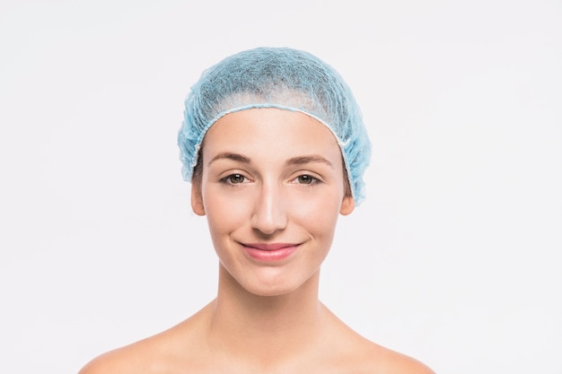 Young woman with bare shoulders in hair cap