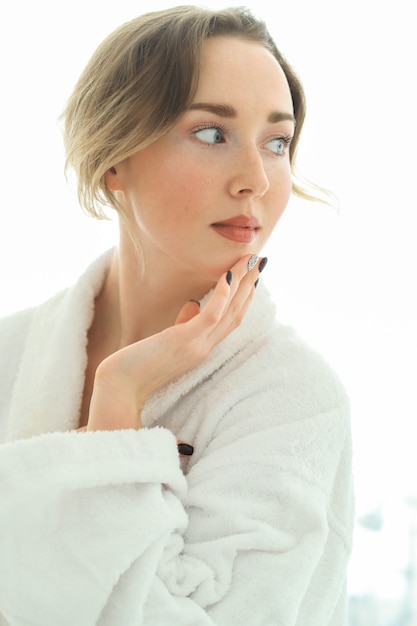 Young woman with bathrobe after shower