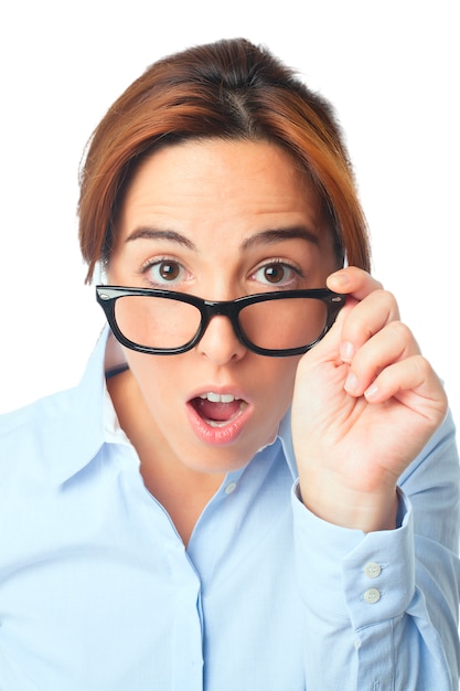 Young woman with black glasses looking surprised