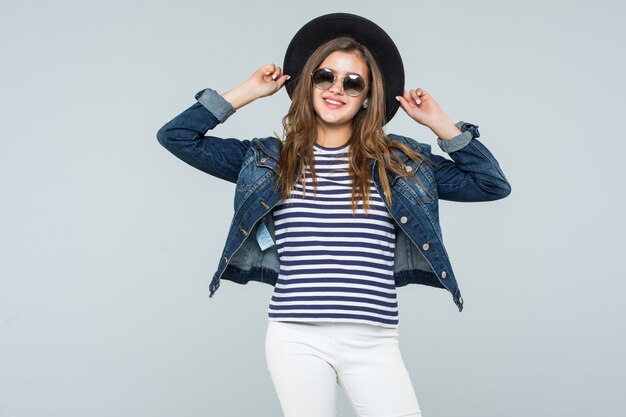 Young woman with black hat and sunglasses isolated on white background