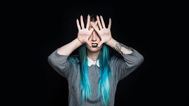 Young woman with black lipstick posing