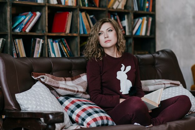 Young woman with book looking away