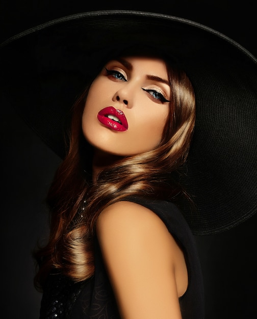 Young woman with bright makeup and black hat