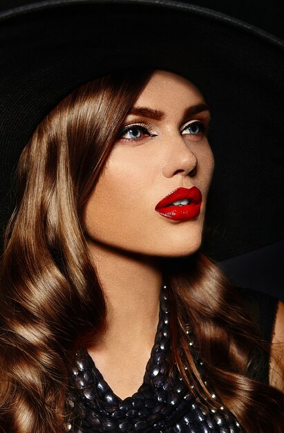 Young woman with bright makeup and black hat
