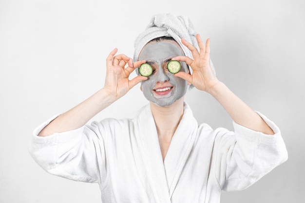 Free photo a young woman with a clay mask on her face