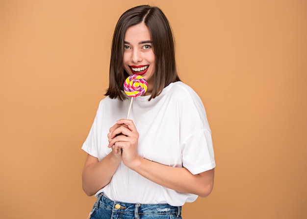 The young woman with colorful lollipop