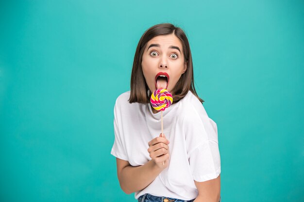 The young woman with colorful lollipop