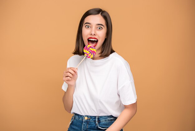 young woman with colorful lollipop