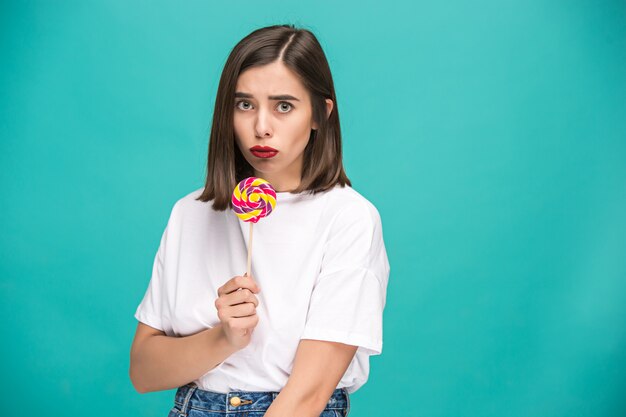 The young woman with colorful lollipop