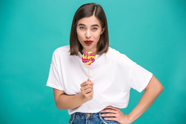 Free photo young woman with colorful lollipop