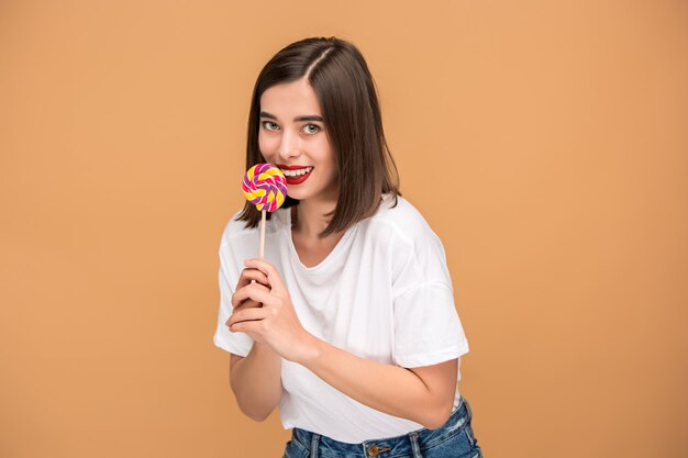 The young woman with colorful lollipop