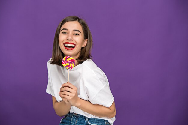 The young woman with colorful lollipop