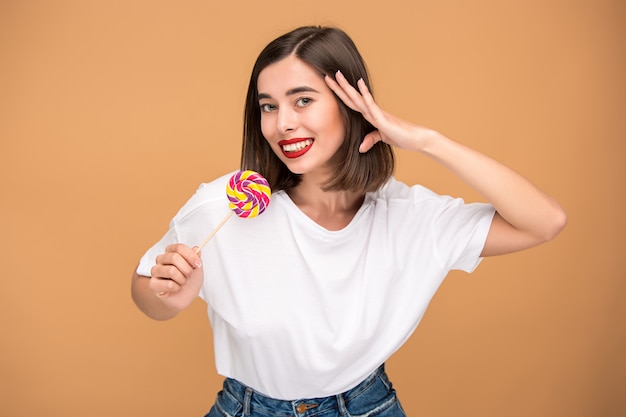 The young woman with colorful lollipop