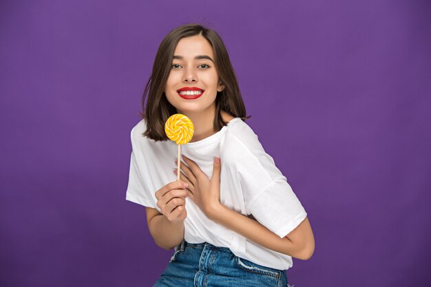 The young woman with colorful lollipop