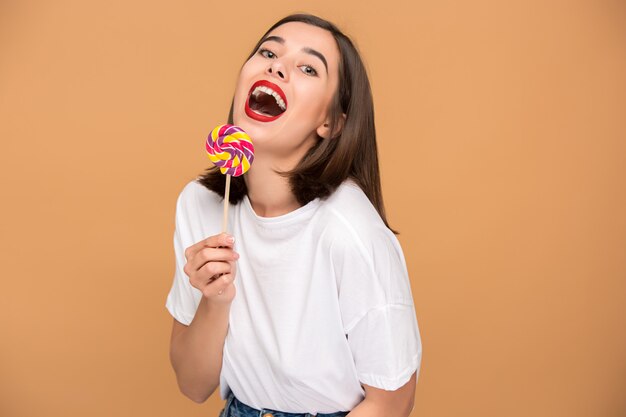 The young woman with colorful lollipop