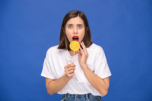 Free photo the young woman with colorful lollipop