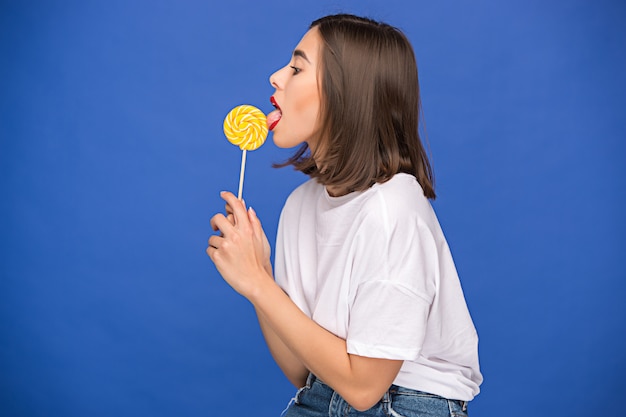 The young woman with colorful lollipop