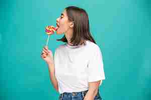 Free photo the young woman with colorful lollipop