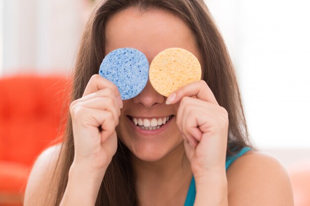 Young woman with cosmetic pillows