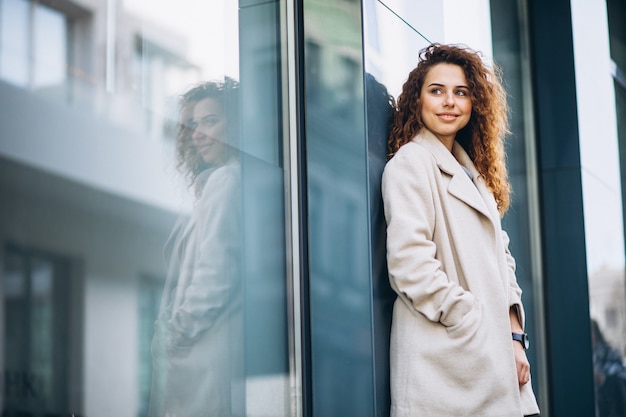 Young woman with curly hair outside the street