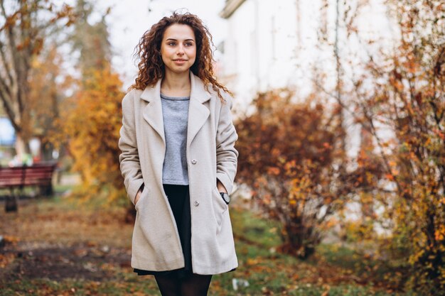 Young woman with curly hair in park