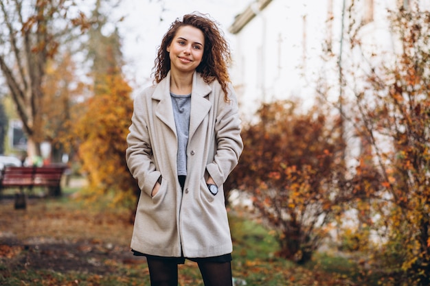 Young woman with curly hair in park