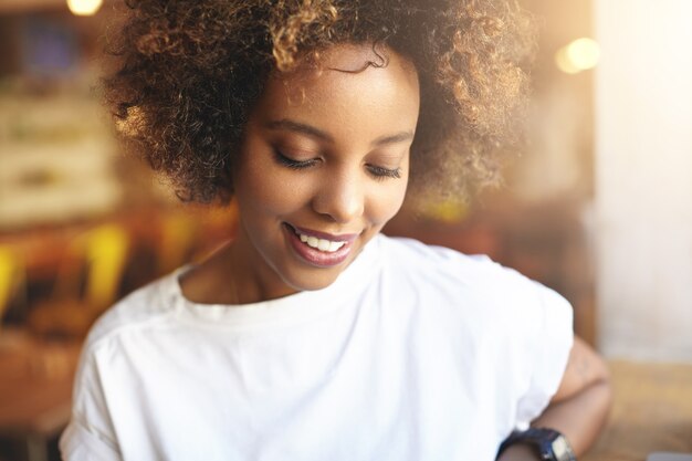 Young woman with curly hair sitting in cafe