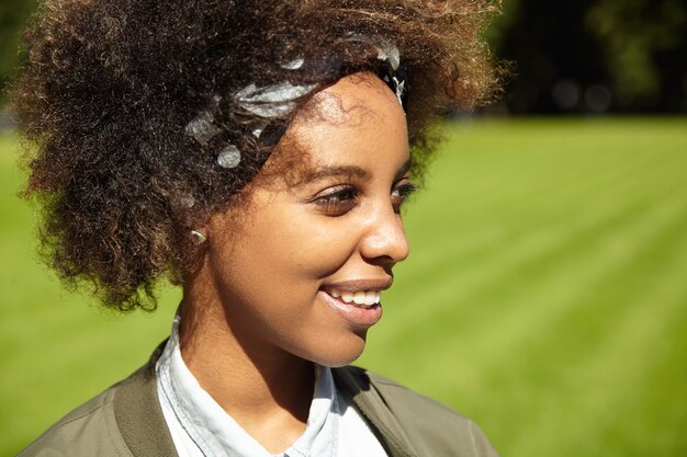 Young woman with curly hair wearing bandana