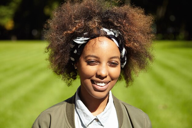 Young woman with curly hair wearing bandana