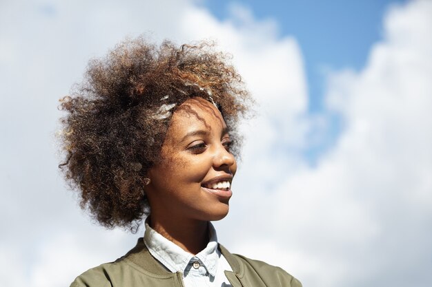 Young woman with curly hair wearing bandana