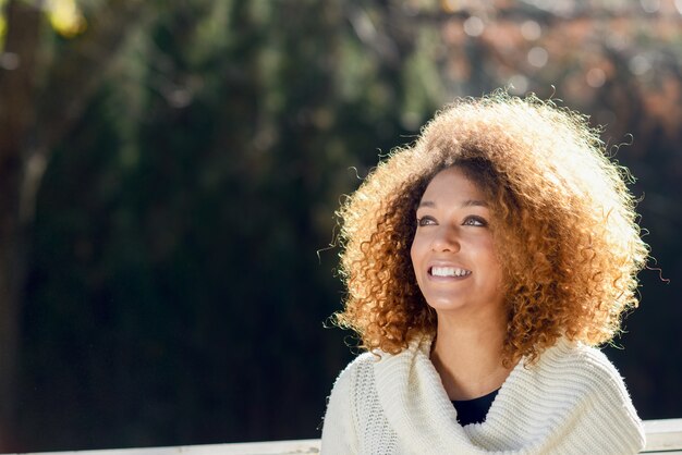 Young woman with curly hair wearing a jersey