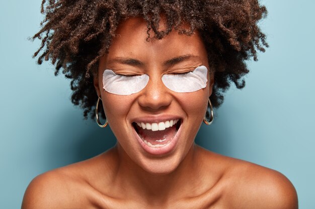 Young woman with curly hair with eye patches