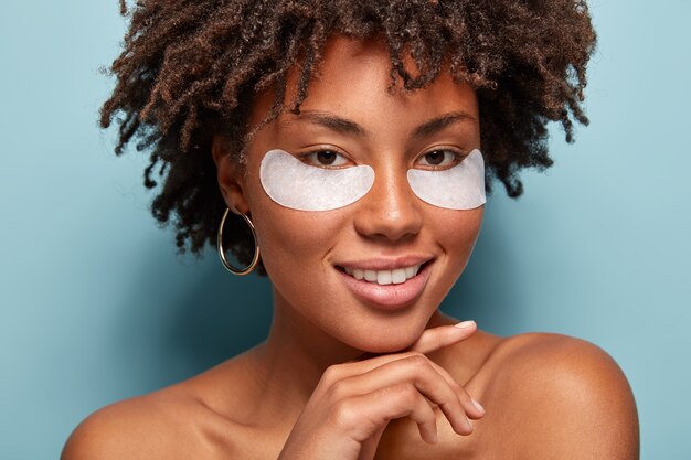 Young woman with curly hair with eye patches