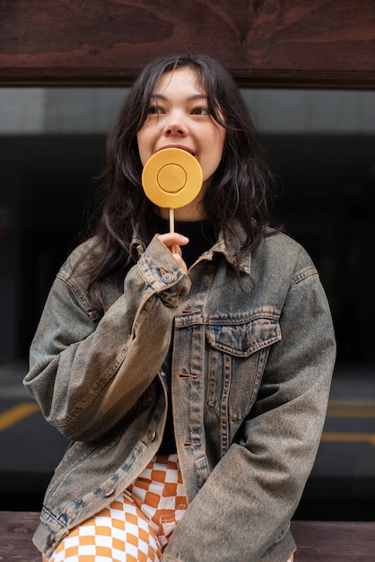 Young woman with dalgona cookie