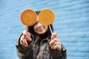 Free photo young woman with dalgona cookie