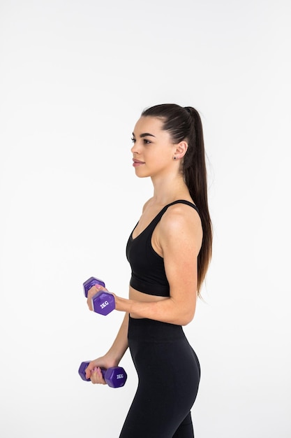 Young woman with dumbbell fit slim abs body isolated on a white background Healthy lifestyle