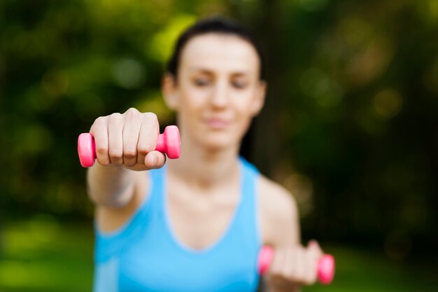 Young woman with dumbbells