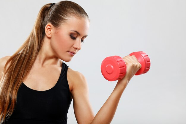 Young woman with dumbells